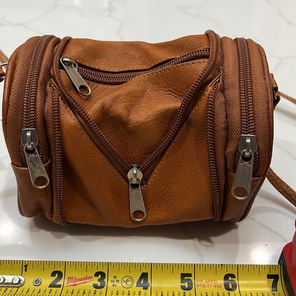 Expandable leather crossbody mini purse. Zips closed - then opens. See pictures.